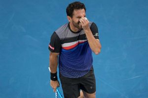 Melzer ousts three-time defending champ Burgos, Monfils prevails