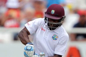 Smith makes fifty on rain-hit second day