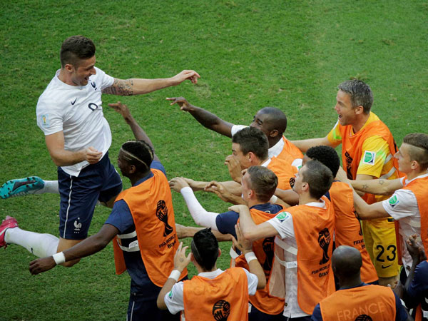 France's Olivier Giroud, left, celebrates after scoring the opening goal