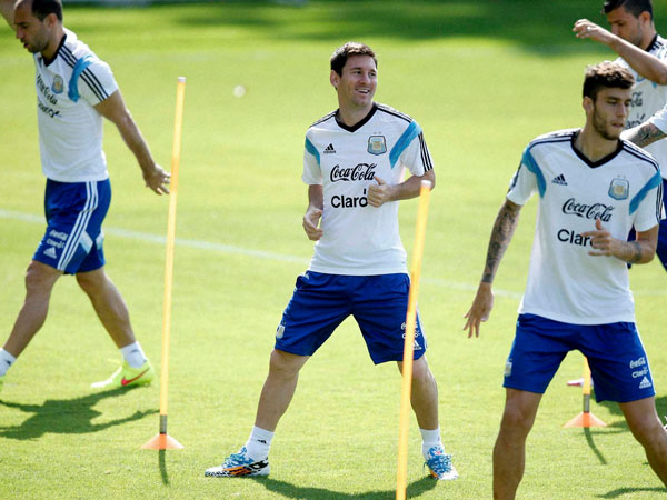 Argentina's Lionel Messi, center, warms up with teammates