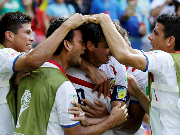 Costa Rica's Bryan Ruiz, center, is congratulated by teammates