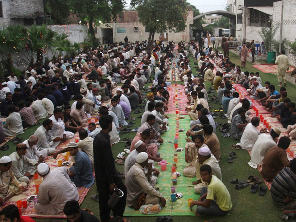 Pakistani Muslims wait to break their fast at sunset