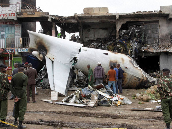 Soldiers look at the wreckage of the Fokker 50 cargo plane