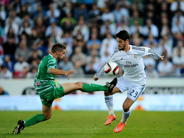 Real Madrid's Francisco Isco, right, duels for the ball 