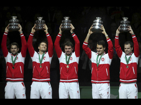 Swiss team, from the left, Michael Lammer, Marco Chiudinelli, Stanislas Wawrinka, Roger Federer and coach Severin Luthi hold their trophy after winning the Davis Cup final at the Pierre Mauroy stadium in Lille, northern France, Sunday Swiss team, from the left, Michael Lammer, Marco Chiudinelli, Stanislas Wawrinka, Roger Federer and coach Severin Luthi hold their trophy after winning the Davis Cup final at the Pierre Mauroy stadium in Lille, northern France, Sunday