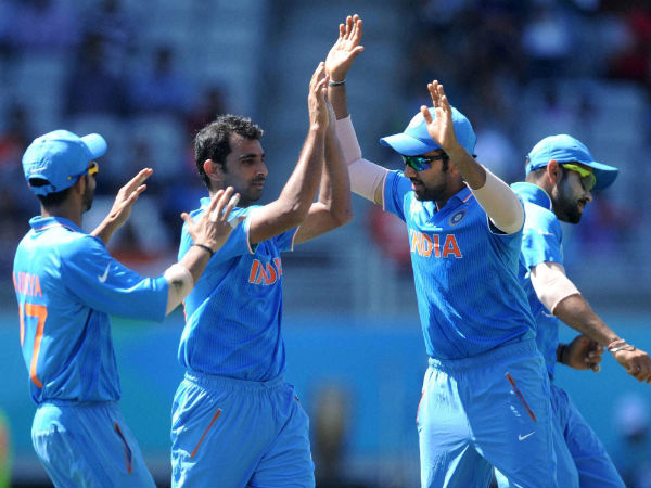 India's Mohammed Shami (centre) is congratulated by teammates after he dismissed one of Zimbabwe's batsman in World Cup 2015
