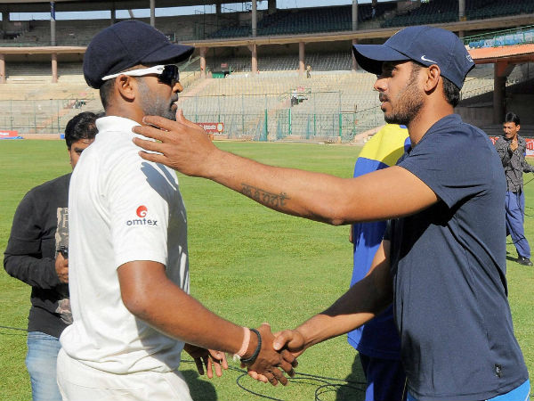 Captain Vinay (left) is congratulated by his counterpart Manoj Tiwary