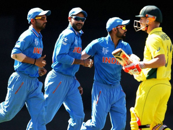 Indian players celebrate an Australian wicket