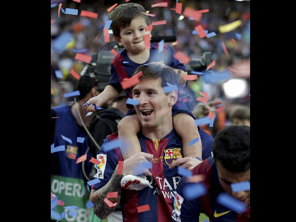 Lionel Messi has a chance to set a record. He is seen here celebrating with his son after winning La Liga title this year
