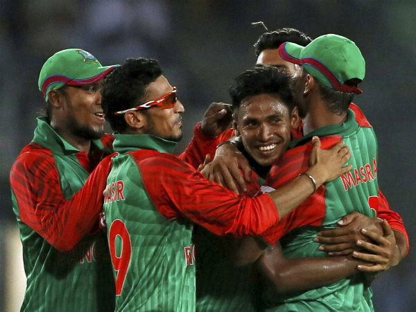 Mustafizur Rahman, centre, celebrates with teammates the dismissal of Suresh Raina