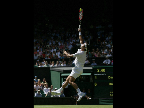 Roger Federer of Switzerland smashes a ball to Damir Dzumhur of Bosnia 