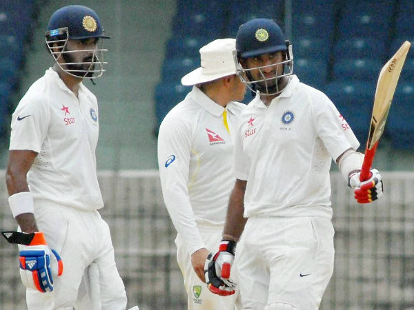 Pujara (right) celebrates his half century Pujara (right) celebrates his half century