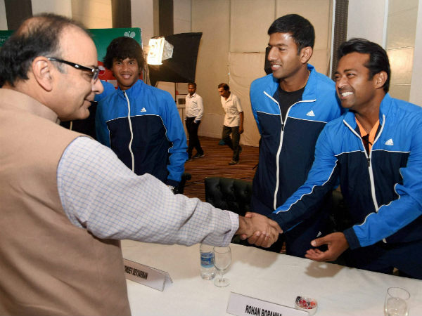 Union Finance Minister Arun Jaitley greets the Indian Davis Cup team members Leander Paes, Rohan Bhopanna and Somdev Devvraman during the announcement of the Davis Cup draw