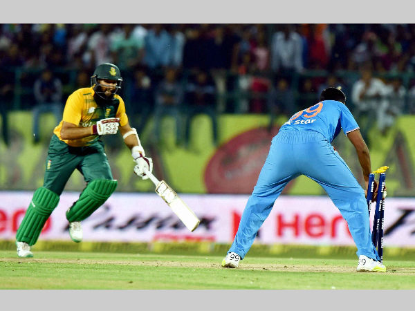 Ashwin (right) runs Amla out
