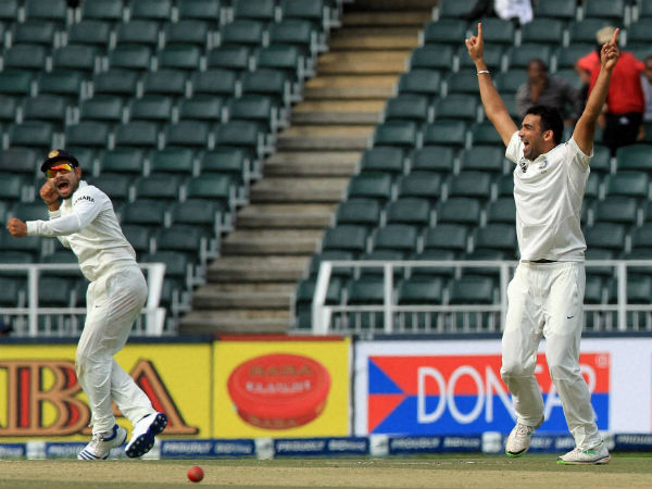Zaheer (right) celebrates a wicket with Virat Kohli