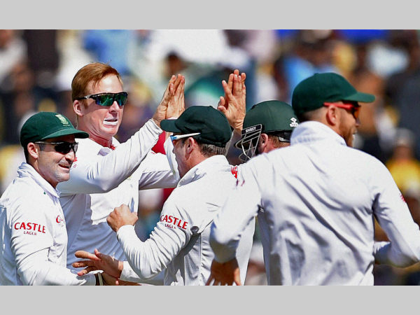 Harmer (second left) celebrates with team-mates after dismissing Pujara