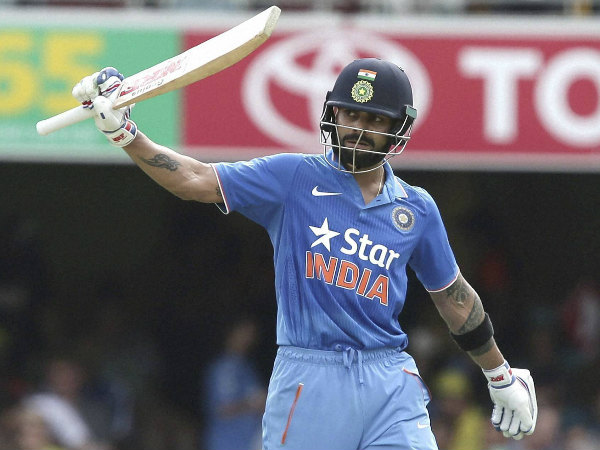 Virat Kohli raises his bat in Brisbane after completing half century