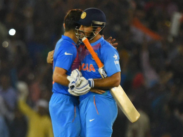 Kohli and Dhoni (right) embrace after the success