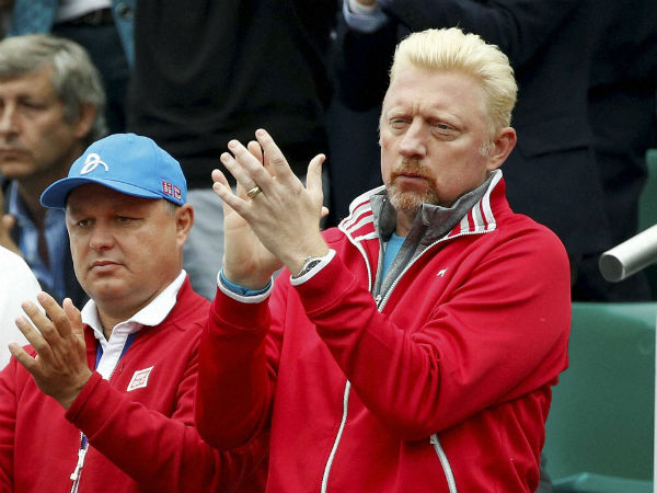 Former German tennis champion Boris Becker applauds as Serbia's Novak Djokovic plays Britain's Andy Murray during their final match of the French Open 