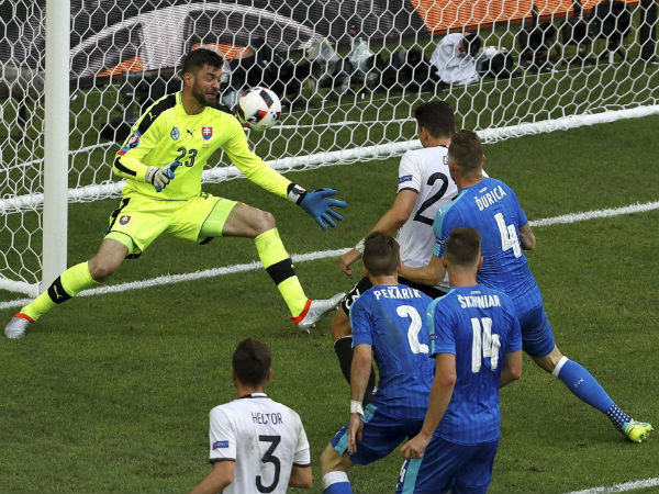 Germany's Mario Gomez, background right, scores his side's second goal besides Slovakia goalkeeper Matus Kozacik, left, during the Euro 2016 round of 16 soccer match between Germany and Slovakia, at the Pierre Mauroy stadium in Villeneuve d'Ascq, near Lille, France, on June 26, 2016.