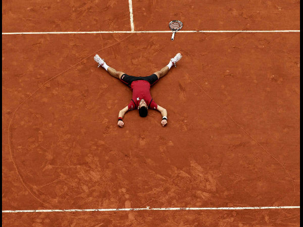 Serbia's Novak Djokovic lays on the clay in a heart in drew after defeating Britain's Andy Murray during their final match of the French Open tennis tournament at the Roland Garros.