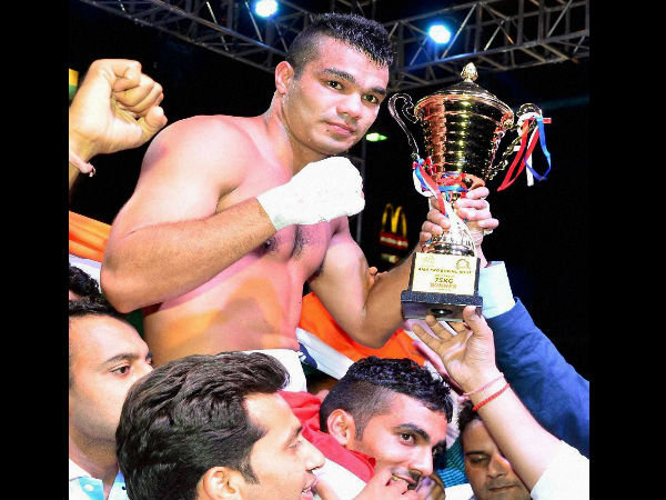ndia's Vikas Krishan Yadav celebrates with trophy after beating Kenya's boxer Nickson Abaka during the AIBA Pro Boxing night in Noida on Saturday.
