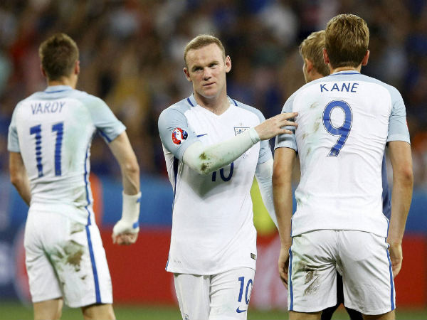 England's Wayne Rooney (center) comforts is teammates at the end of the Euro 2016 England's Wayne Rooney (center) comforts is teammates at the end of the Euro 2016