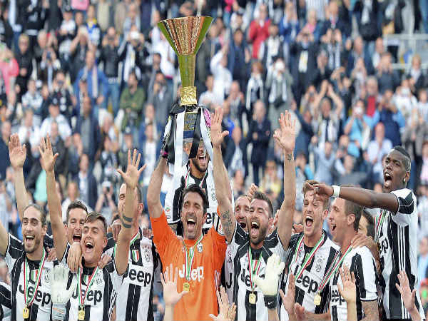 Juventus' Gianluigi Buffon holds up the trophy as he celebrates with teammates their Serie A title Juventus' Gianluigi Buffon holds up the trophy as he celebrates with teammates their Serie A title