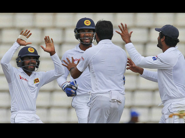 Sri Lankan team members celebrate the dismissal of Australia's Usman Khawaja with their bowler Dilruwan Perera, second right, on day four of the first test cricket match between Sri Lanka and Australia in Pallekele.