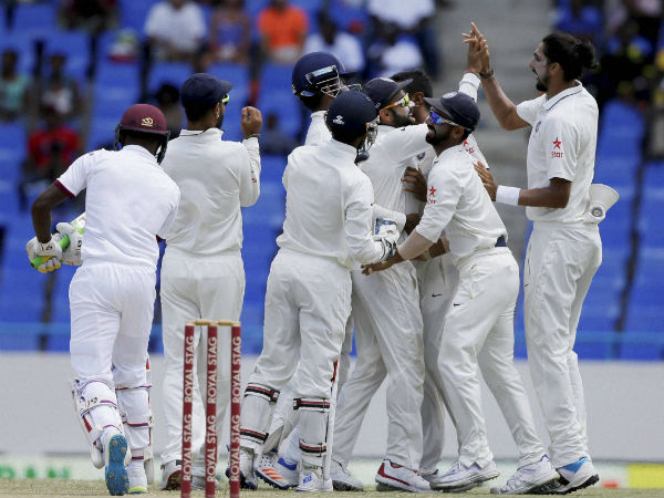 Indian players congratulate captain Virat Kohli after he caught West Indies' Jermaine Blackwood, left, during day four of their first cricket Test match at the Sir Vivian Richards Stadium