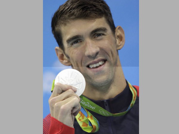 Michael Phelps shows off his silver medal in the men's 100-meter butterfly medals ceremony Michael Phelps shows off his silver medal in the men's 100-meter butterfly medals ceremony