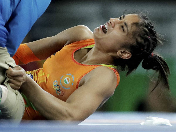 India's Vinesh Vinesh reacts as she is attended to by a doctor after getting injured in her match against China's Sun Yanan during the women's wrestling freestyle 48-kg competition at the 2016 Summer Olympics in Rio de Janeiro, Brazil, Wednesday.