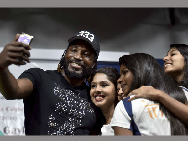 West Indies cricketer Chris Gayle taking a selfie with students during a function at a private college in Chennai