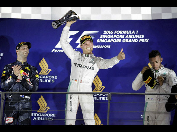Mercedes driver Nico Rosberg of Germany celebrates after winning the Singapore Formula One Grand Prix on the Marina Bay City Circuit Singapore, Sunday, Sept. 18, 2016.Red Bull driver Daniel Ricciardo, left, of Australia finished second and Mercedes driver Lewis Hamilton, right, of Britain third.