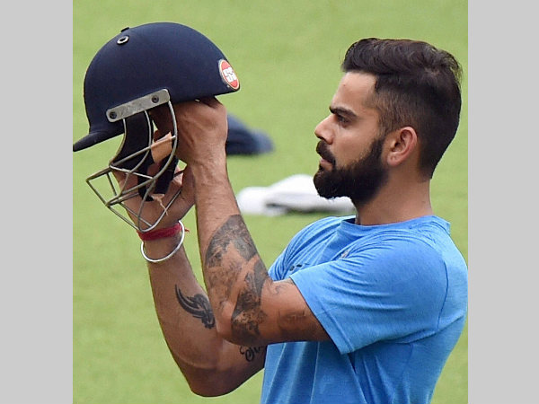 Kohli checks his helmet during a practice session in Kolkata on Wednesday (September 28) Kohli checks his helmet during a practice session in Kolkata on Wednesday (September 28)
