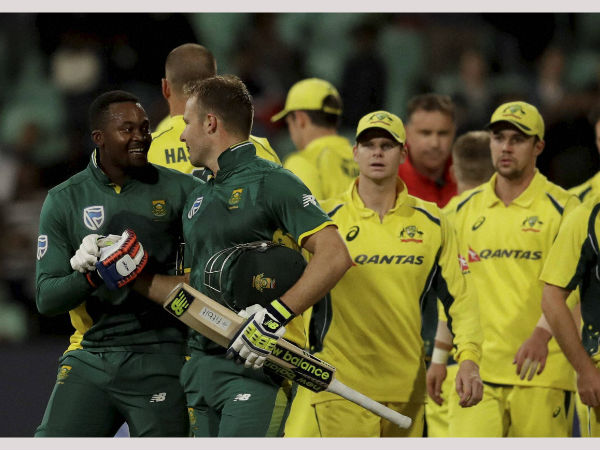 Andile Phehlukwayo, left, with teammate David Miller, leaves the field after scoring the winning runs during the third one-day international cricket match between South Africa and Australia, at Kingsmead stadium in Durban