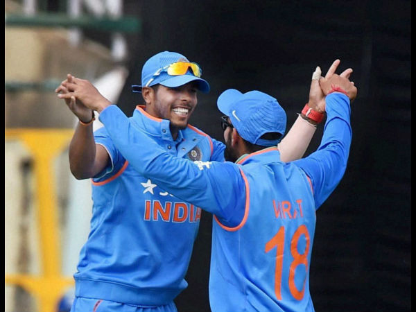 India's Umesh Yadav and Virat Kohli celebrate the dismissal of New Zealand batsman C Anderson in the first ODI match in Dharamsala on Sunday.