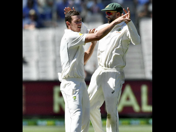 Australia's Josh Hazlewood, left, celebrates with team mate Nathan Lyon, right, capturing the wicket of Pakistan's Azhar Ali on the fifth day of their second cricket test in Melbourne