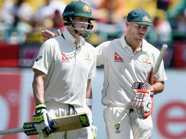 Smith (left) and Warner leave the field after lunch break on day 1 in Dharamsala