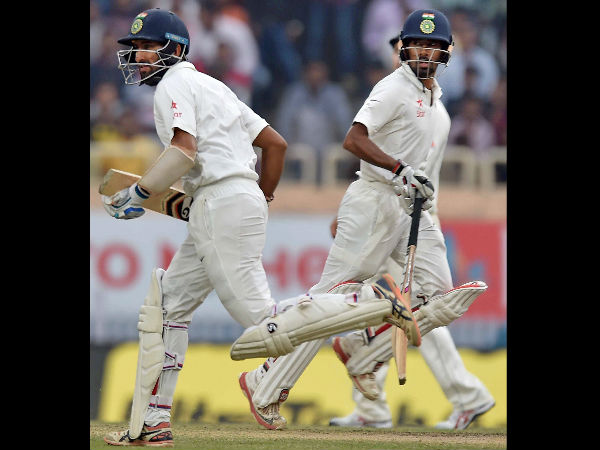  Cheteswar Pujara and Wriddhiman Saha cross each other to complete a run during 4th day of 3rd Test 