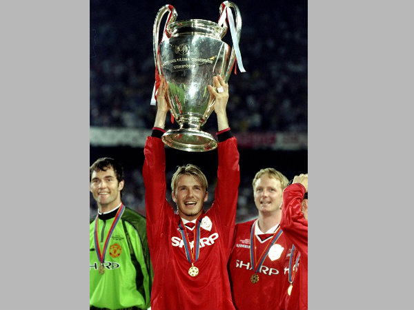 David Beckham in Manchester United colours holding the UCL trophy
