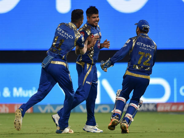 Karn Sharma (centre) celebrates a wicket