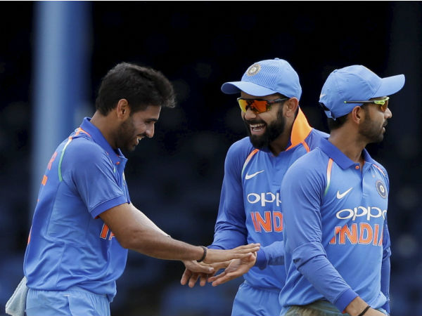 Bhuvneshwar Kumar, left, celebrates with team captain Virat Kohli the dismissal of West Indies' Jason Mohammed during the second ODI