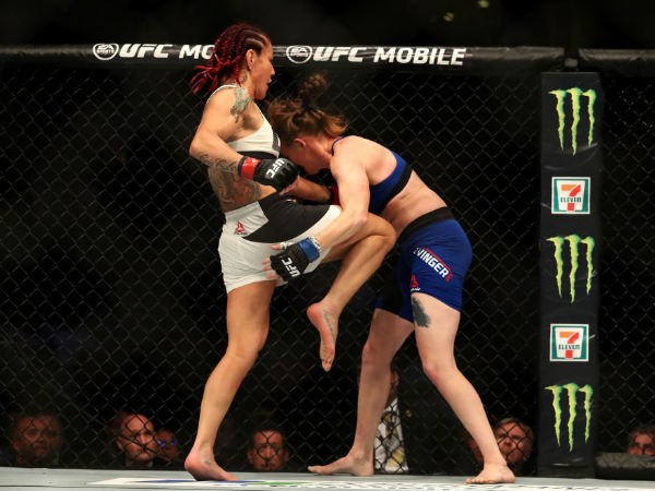 New champion Cris Cyborg with a knee to the gut