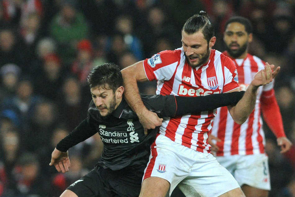 Liverpool’s Adam Lallana, left, is challenged by Stoke City’s Erik Pieters Liverpool’s Adam Lallana, left, is challenged by Stoke City’s Erik Pieters