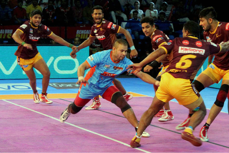 U P Yoddha players try to catch Bengal Warriors players Vinod Kumar during their Pro Kabaddi League match in Nagpur U P Yoddha players try to catch Bengal Warriors players Vinod Kumar during their Pro Kabaddi League match in Nagpur