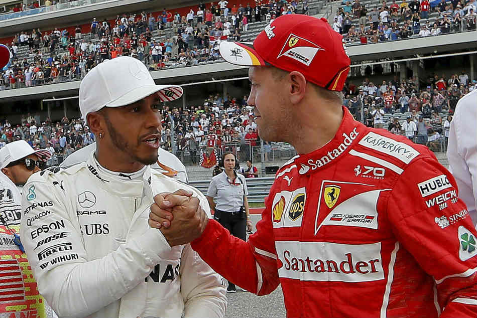 Mercedes' Lewis Hamilton is congratulated by Ferrari's Sebastian Vettel Mercedes' Lewis Hamilton is congratulated by Ferrari's Sebastian Vettel