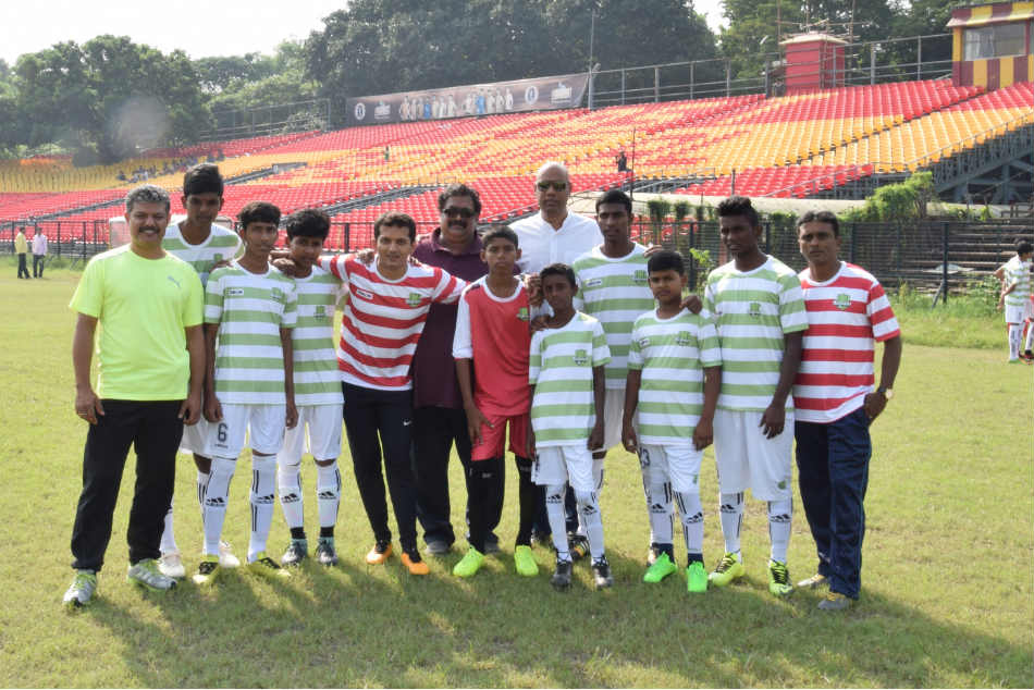 Kickstart FC Foundation kids pose with the support staff ahead of their friendly against East Bengal