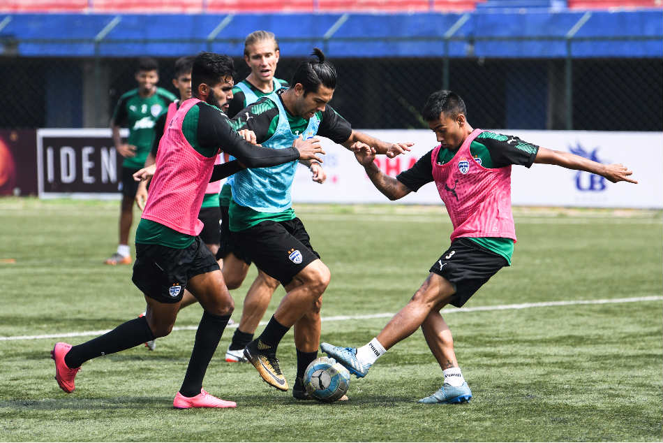 Bengaluru FC's Miku attempts to dribble past defender Subhasish Bose and Collin Abranches (right) during a training session Bengaluru FC's Miku attempts to dribble past defender Subhasish Bose and Collin Abranches (right) during a training session