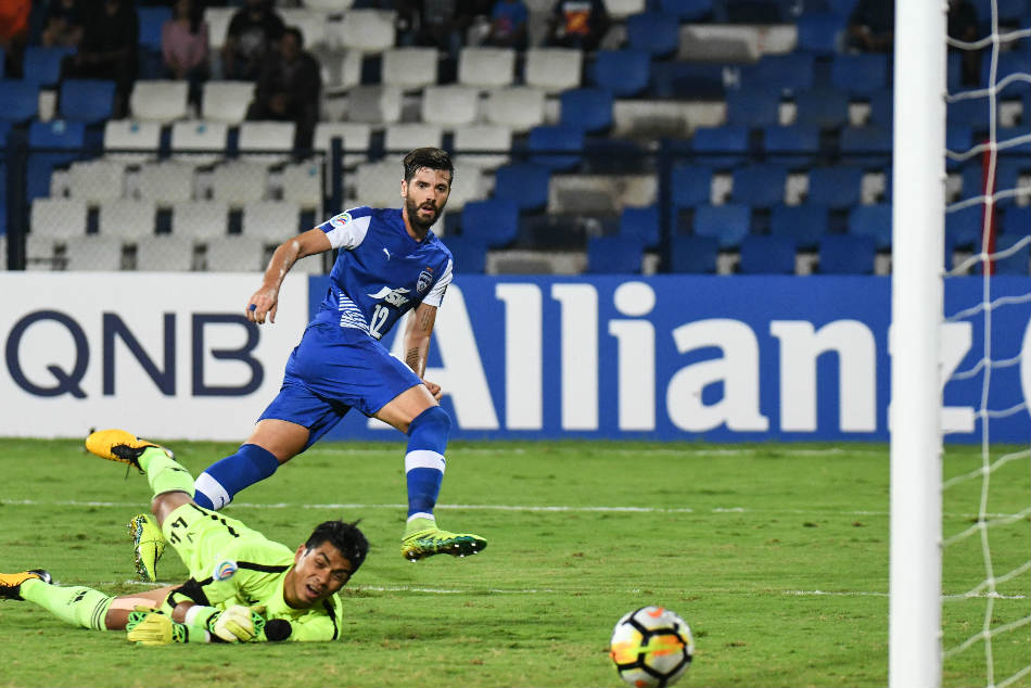 Daniel Segovia of Bengaluru FC scores past Lalawmpuia of Aizawl FC during their AFC Cup game at the Sree Kanteerava Stadium on Wednesday